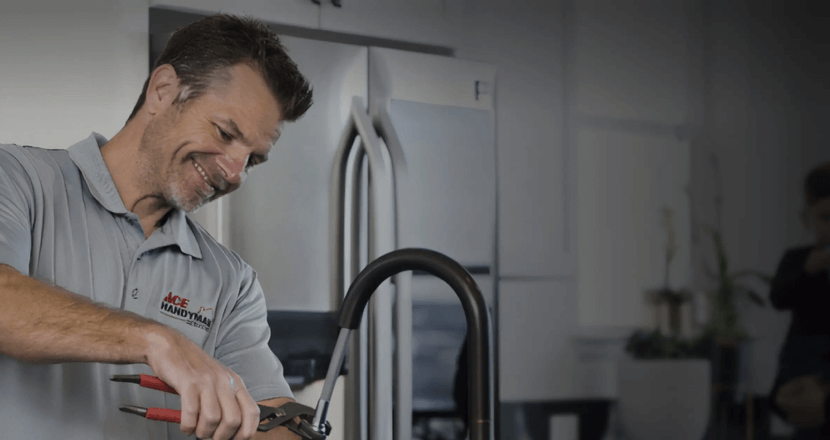 A man doing plumbing work with smiling face