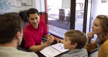 a young tutor interacting with a family
