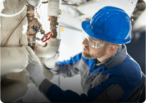 A man fixing a broken pipe