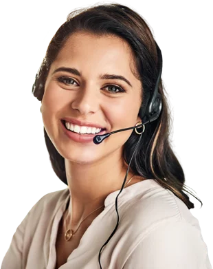 A young woman in peach dress wearing headphones and smiling at the camera.