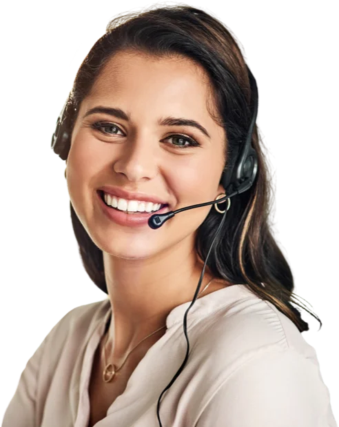 A young woman in peach dress wearing headphones and smiling at the camera.