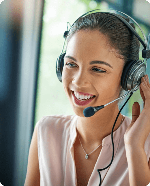 A smiling man in blue shirt looking at his phone