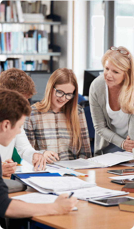 an elderly woman teaching to a group of students