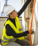 woman measuring wall length